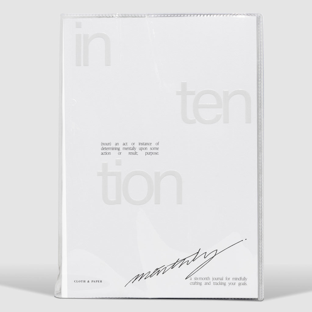 Intention Notebook, Cloth and Paper. Notebook in clear vinyl case displayed on a neutral background.