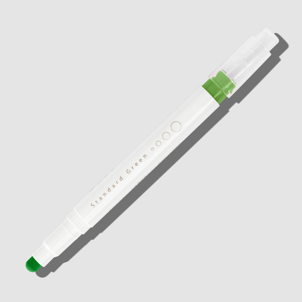 Standard Green highlighter with tip exposed and cap posted to the end of its barrel on a white background.