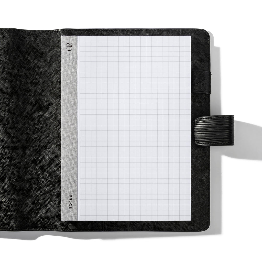 Notepad in use inside a black leather folio.