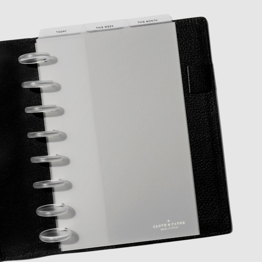 Half Letter Black Foil Cadence Tab Dividers displayed in a black leather planner.