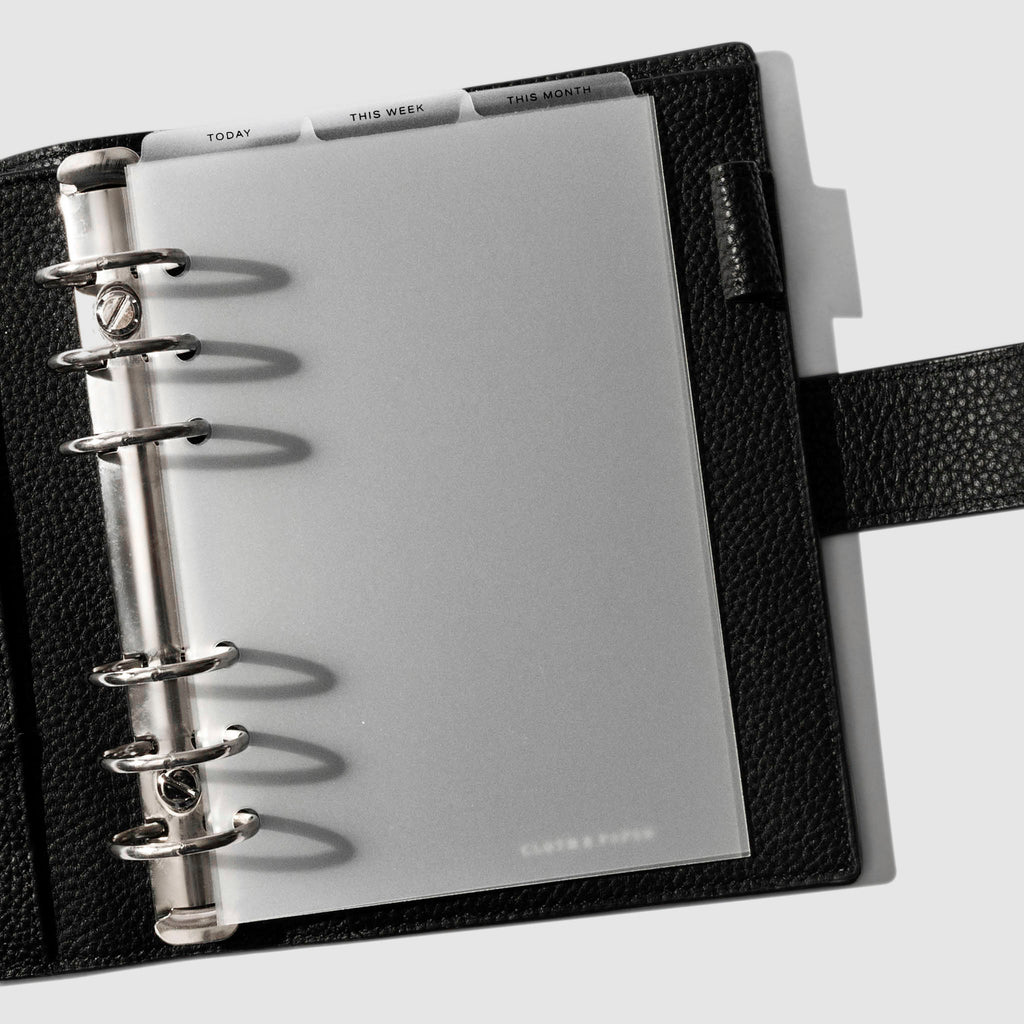 Personal Wide Black Foil Cadence Tab Dividers displayed in a black leather planner.