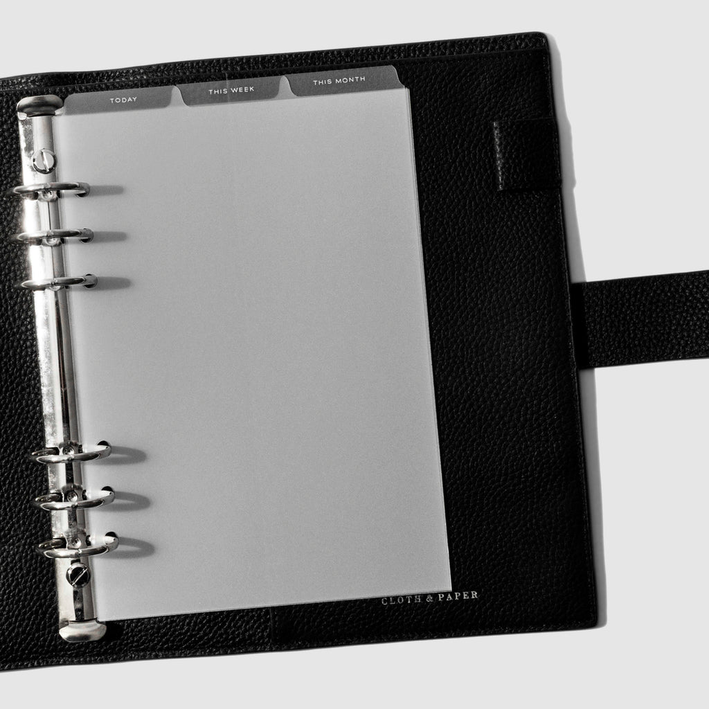 A5 6-Ring White Foil Cadence Tab Dividers displayed in a black leather planner.