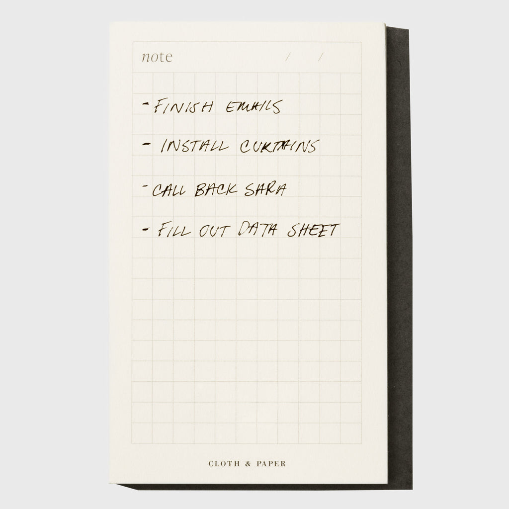 Notepad displayed on a neutral background. A task list is written out on it, as follows: "Finish emails / Install curtains / Call back Sara / Fill out data sheet"