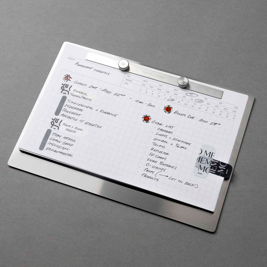 Modern Bound Notepad Insert Refills, executive notes, filled on the Modern Bound Notepad board. The inserts are filled with notes and stickers, showing them in use, resting on a gray table, angled to the left