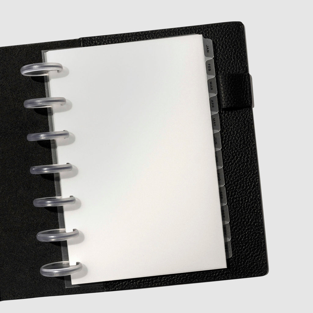 Black foil tabs displayed in use inside a black leather folio.