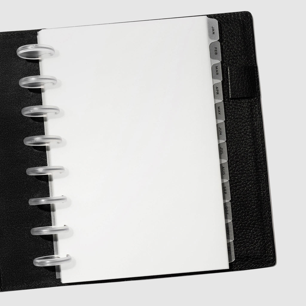 Black foil tabs displayed in use inside a black leather folio.