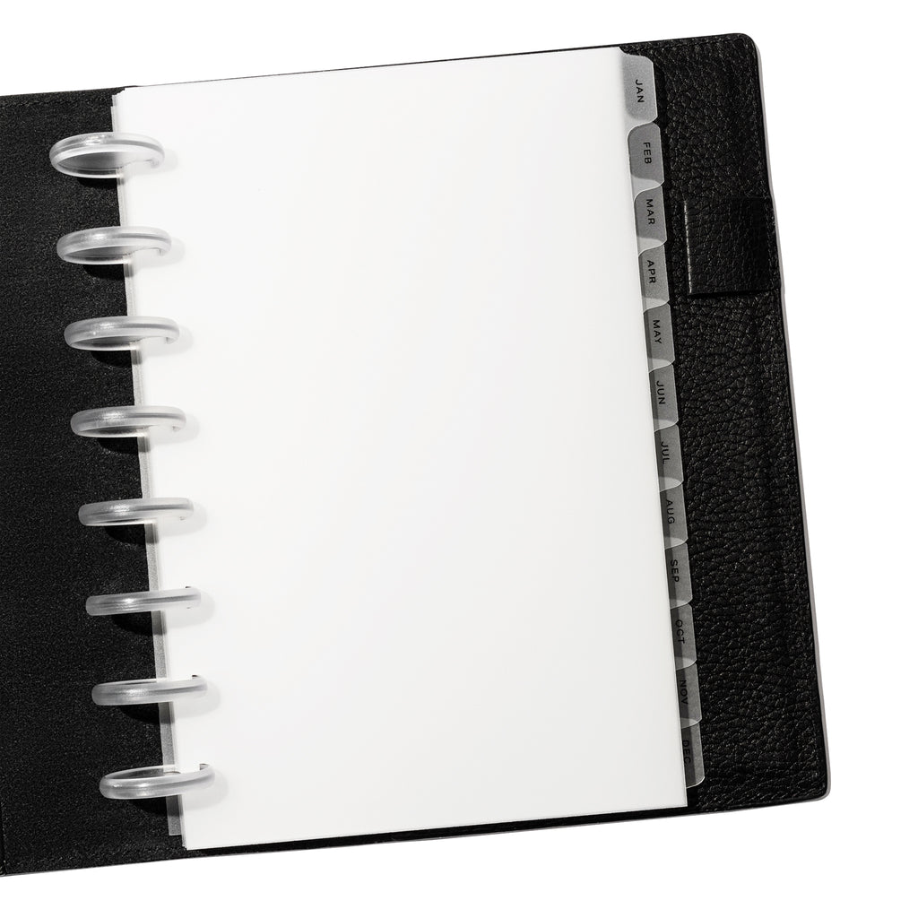 Matte Monthly Side Tab Low Profile dividers shown in use inside a black leather agenda. Size shown is Half Letter. 