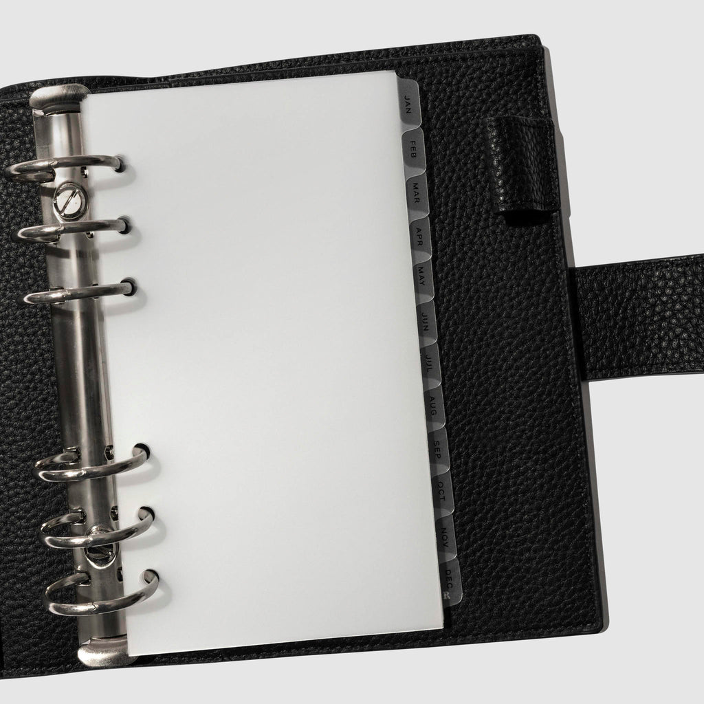 Black foil tabs displayed in use inside a black leather folio.