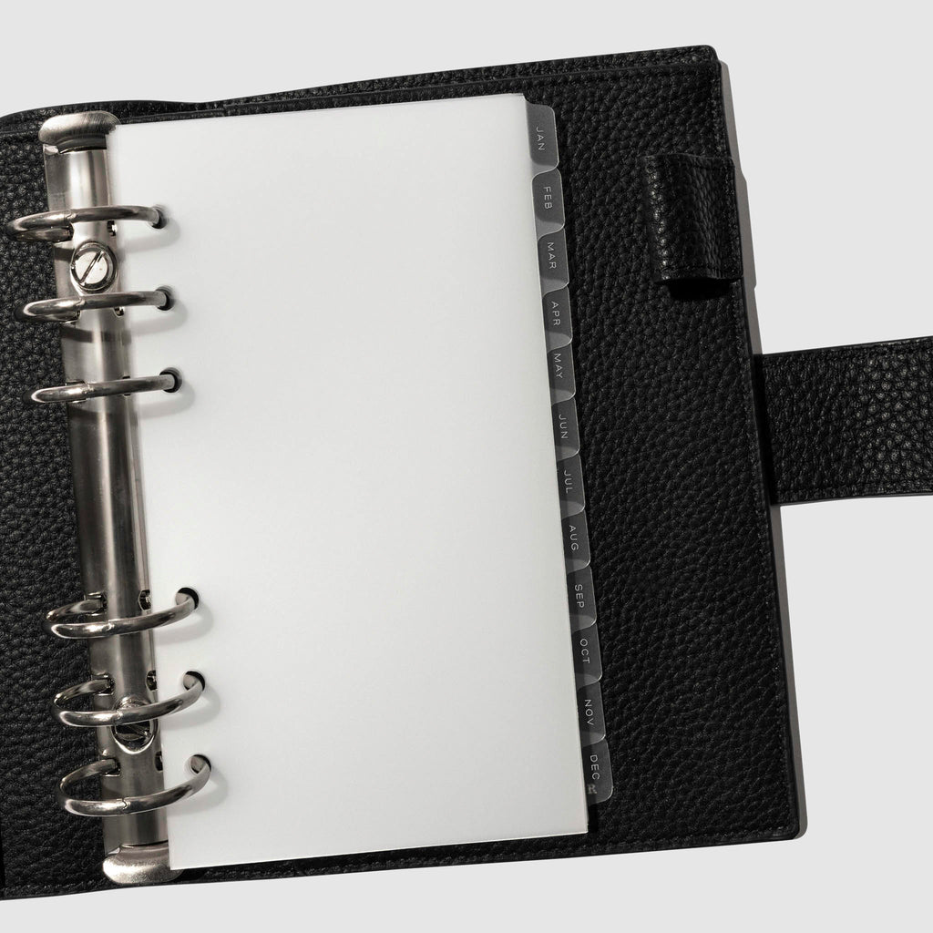 White foil tabs displayed in use inside a black leather folio.