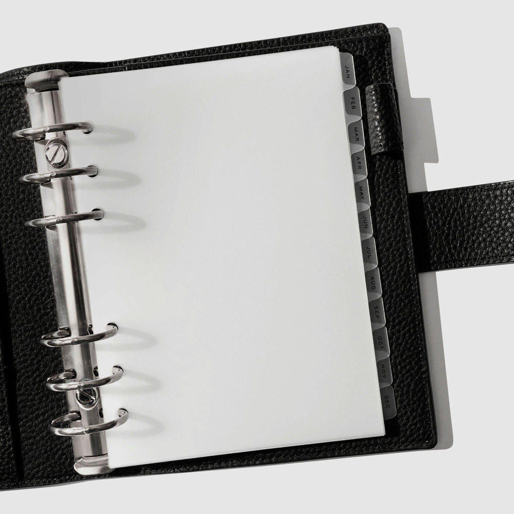 Black foil tabs displayed in use inside a black leather folio.