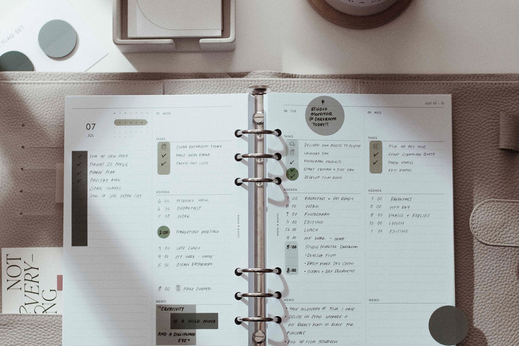 A Leather 6-Ring Agenda is opened on a desk.  Inside the planner is a filled out 2025 Insert.