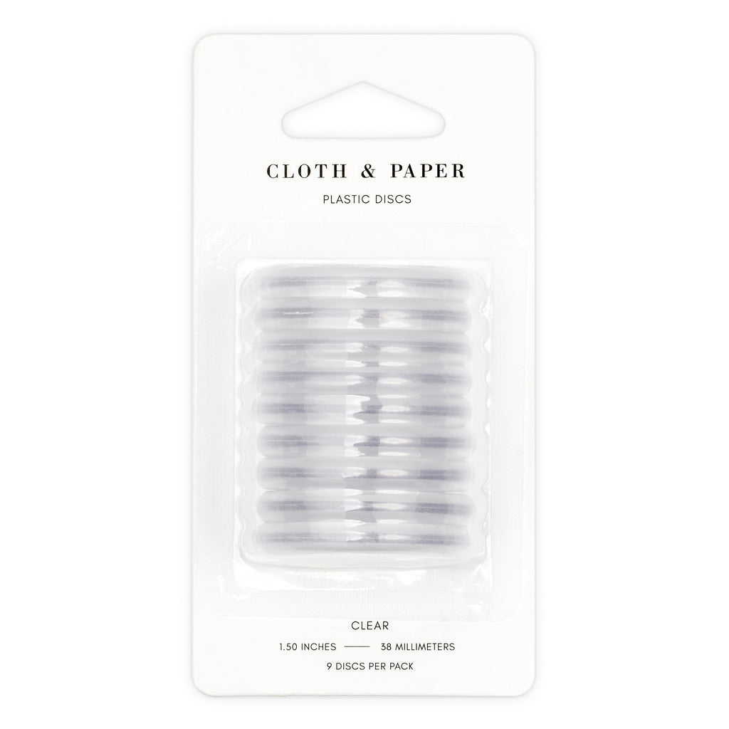 Clear planner discs displayed in their packaging on a white background.