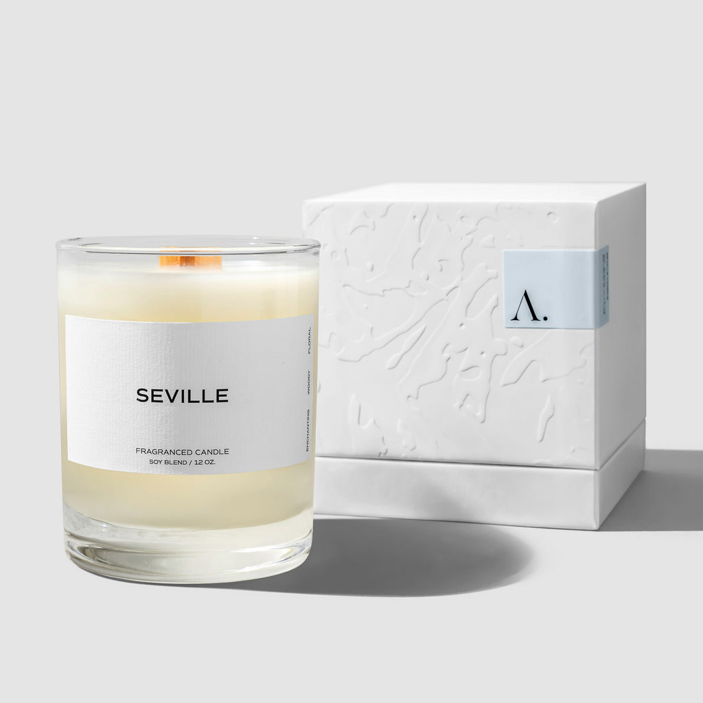 Candle displayed next to its box on a neutral background.