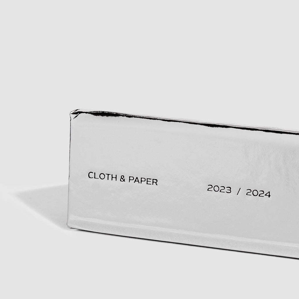 Closeup of the book's spine. Text reads "Cloth & Paper | 2023/2024"