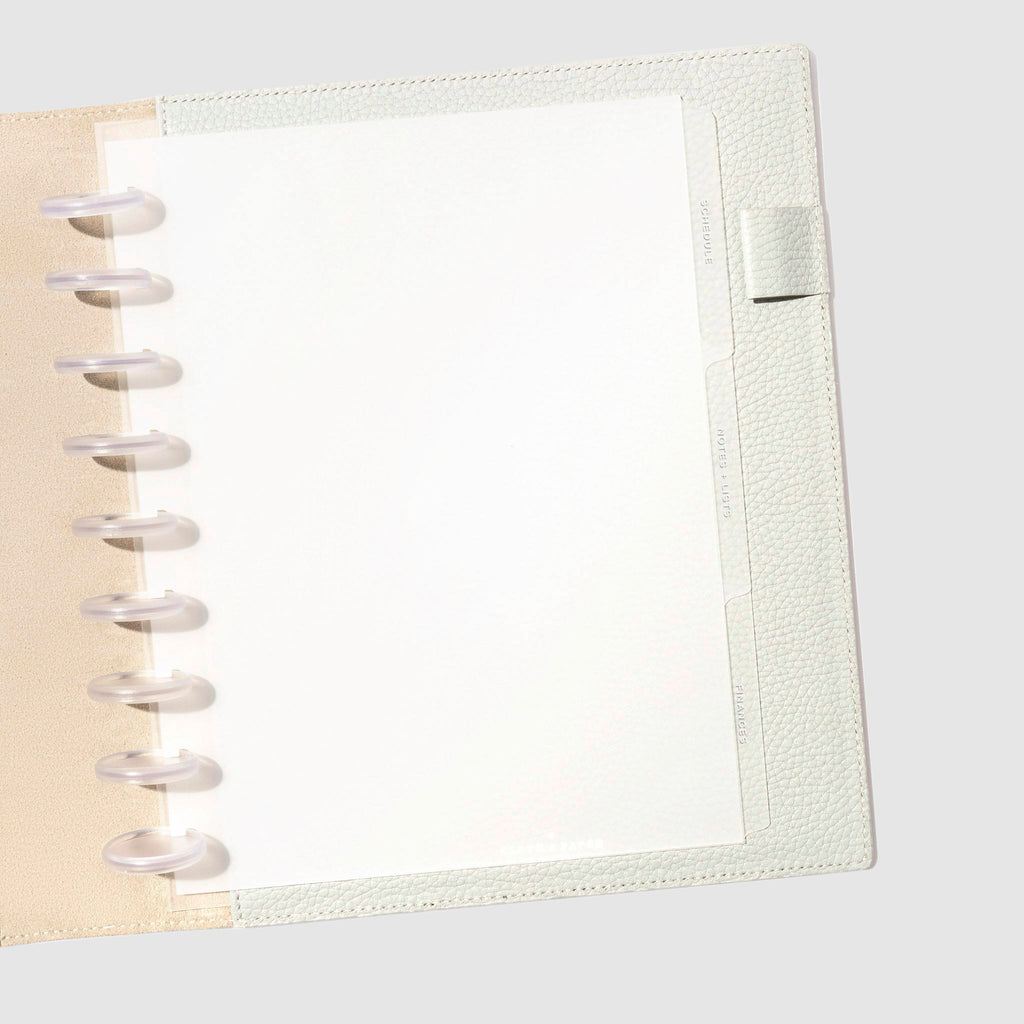 White foil tabs displayed in use inside a  leather folio.