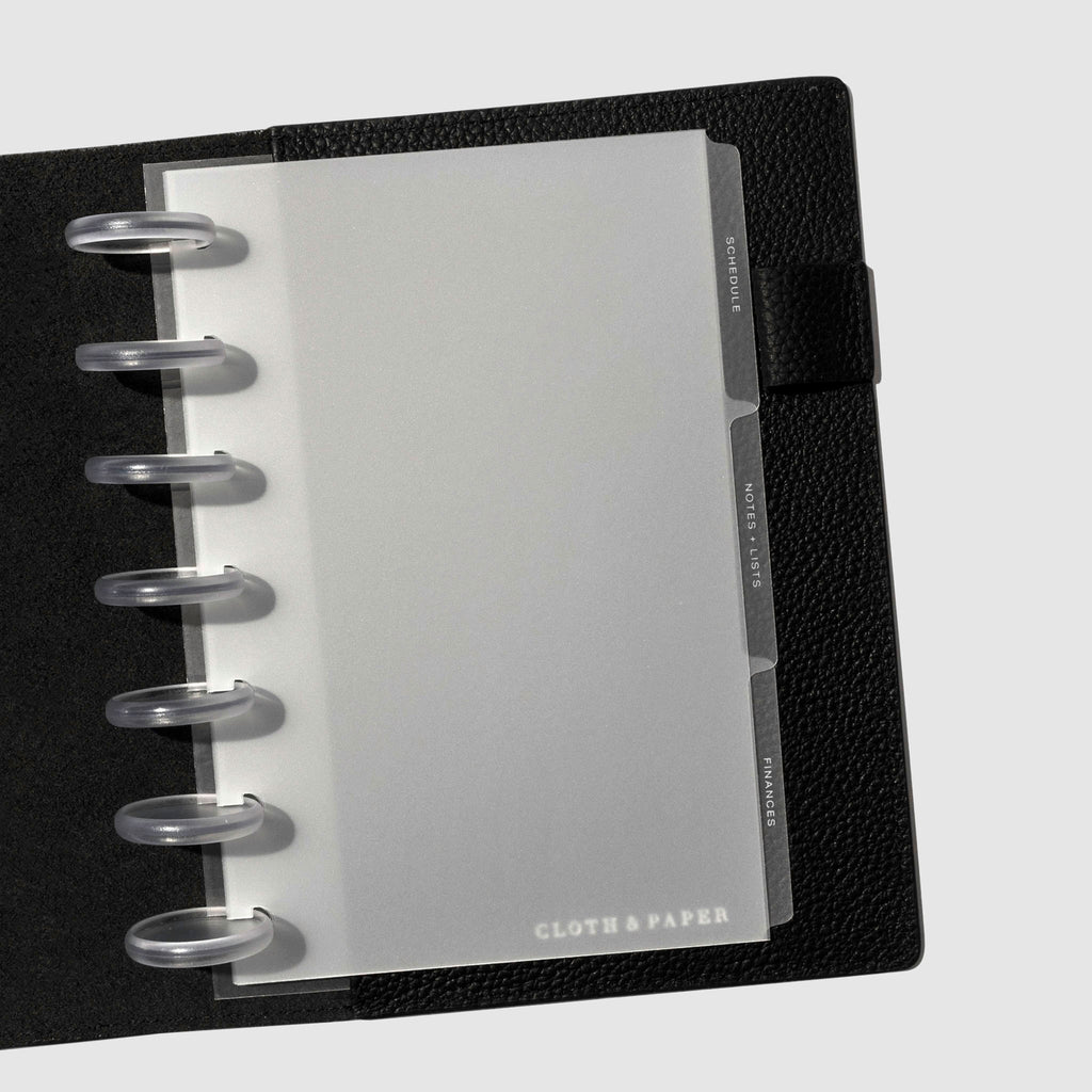 White foil tabs displayed in use inside a  leather folio.