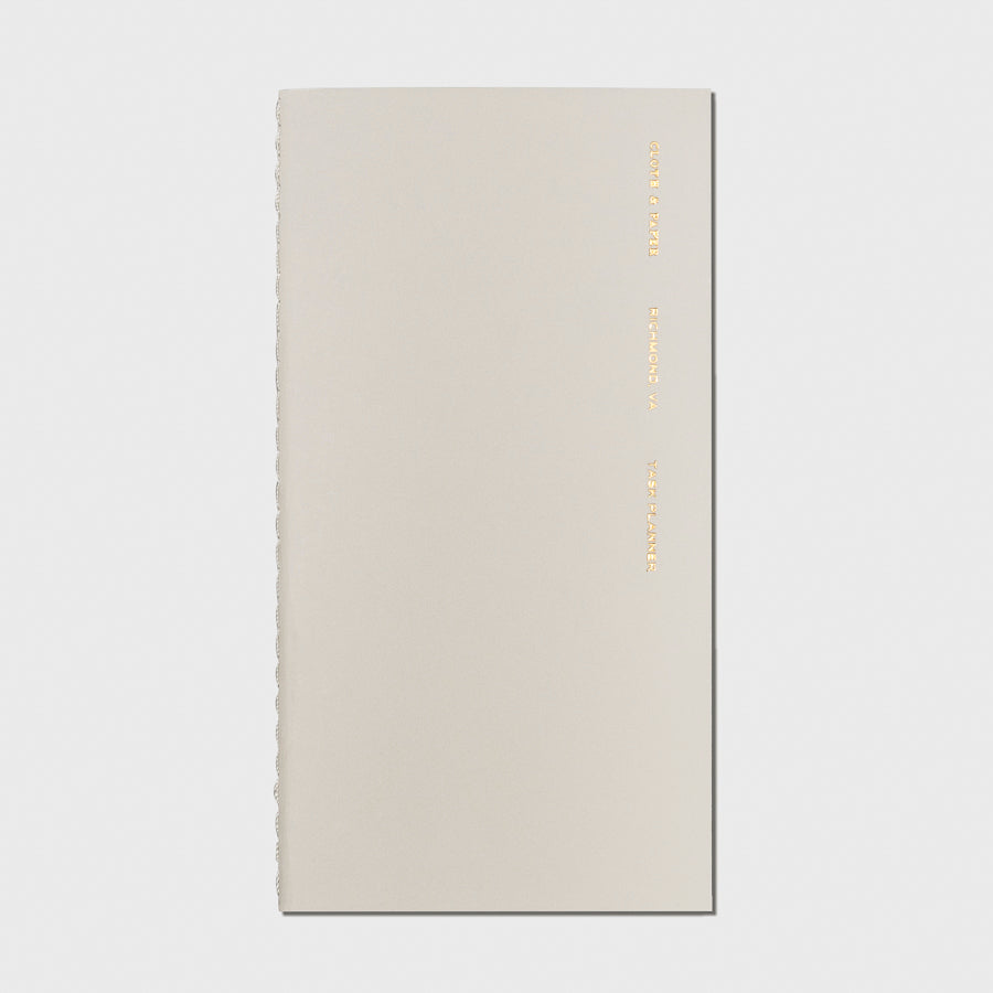 Overview image of the Ristretto Task Planner Pocket Plus notebook from the Traveler's Notebook Collection. The cover has gold foil text that reads Cloth and Paper Richmond, VA Task Planner and is displayed on a light gray background