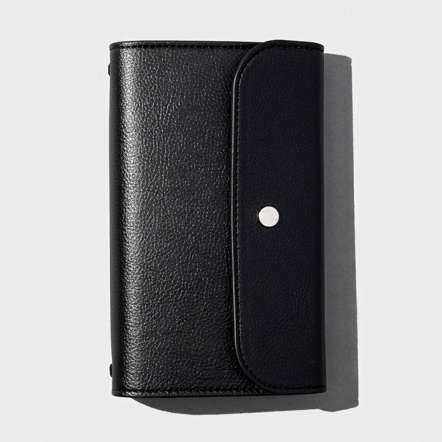 Black leather cover with silver snap displayed on a light gray background