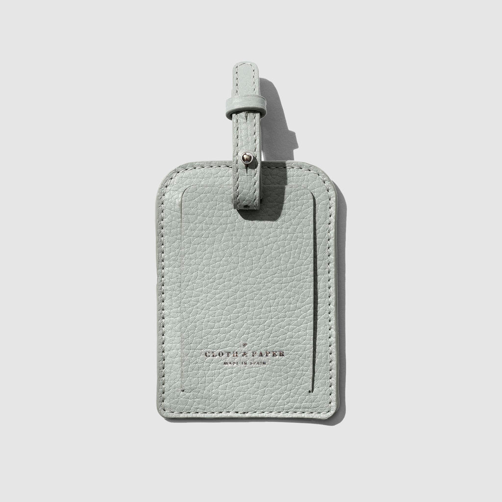 Luggage tag displayed on a neutral background.