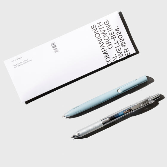 Pen set shown with its packaging on a neutral background.