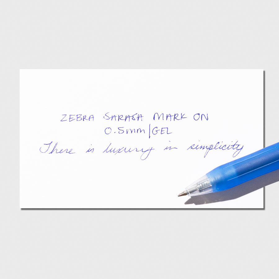 Blue pen displayed on top of a writing sample.