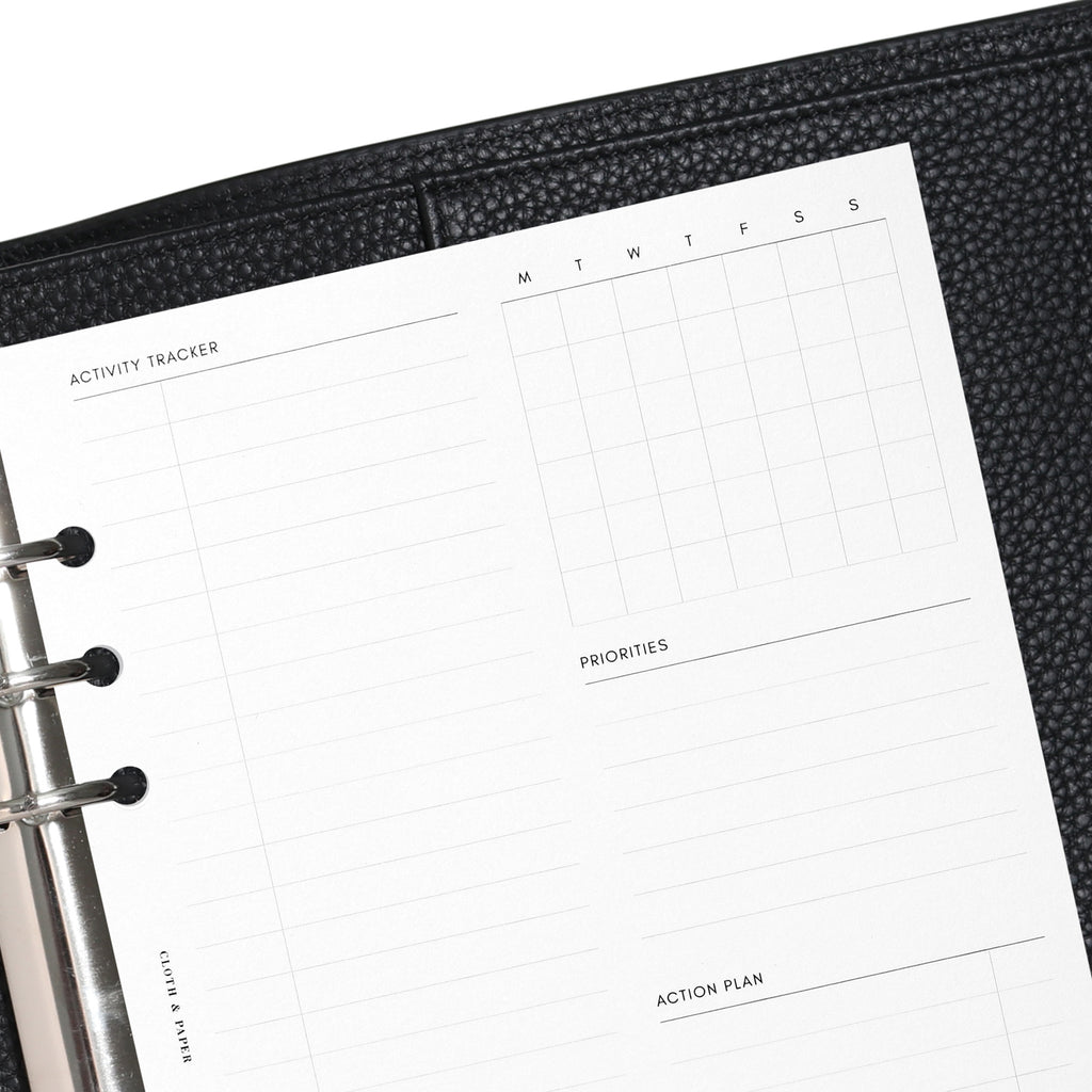 Closeup of A5 insert in use inside a black leather planner.