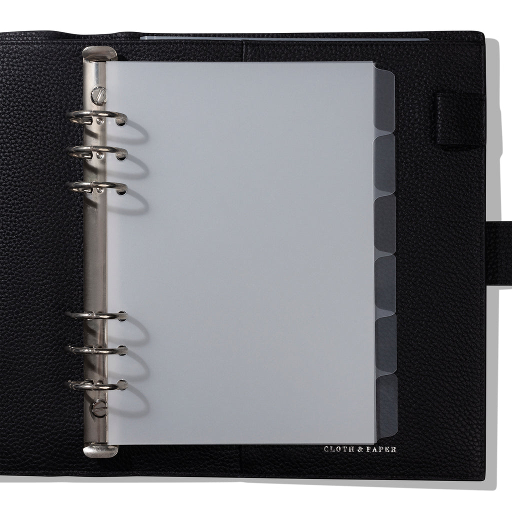 Dividers in use inside a black leather planner. 