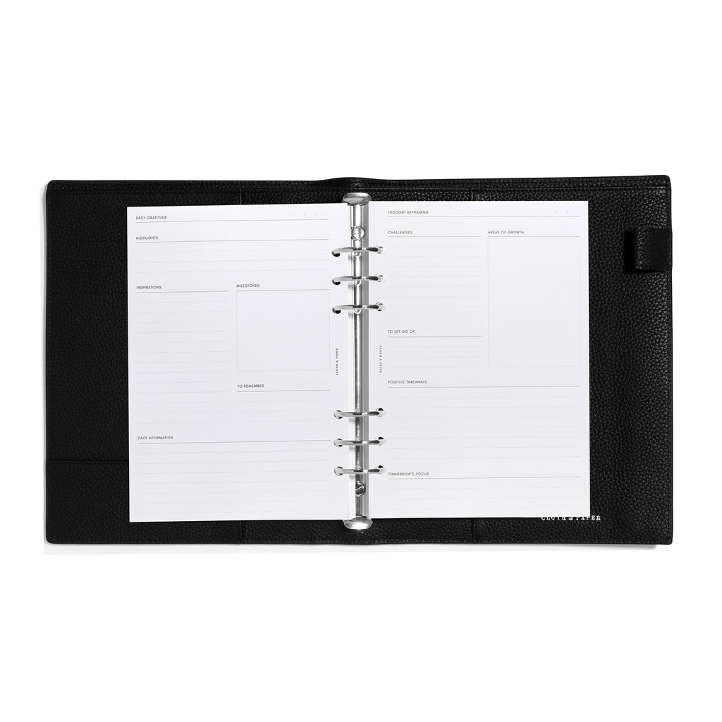 Inserts in use inside a black leather agenda.