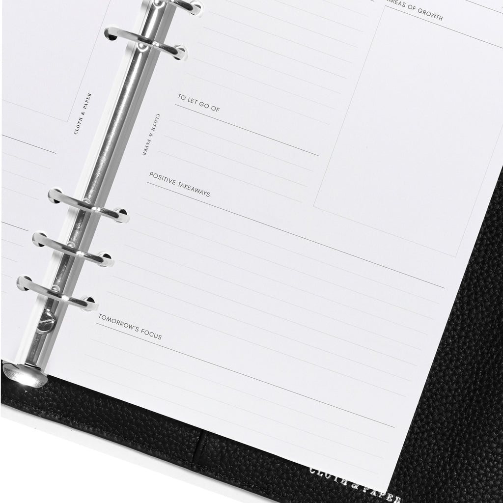 Closeup of inserts inside black leather agenda.