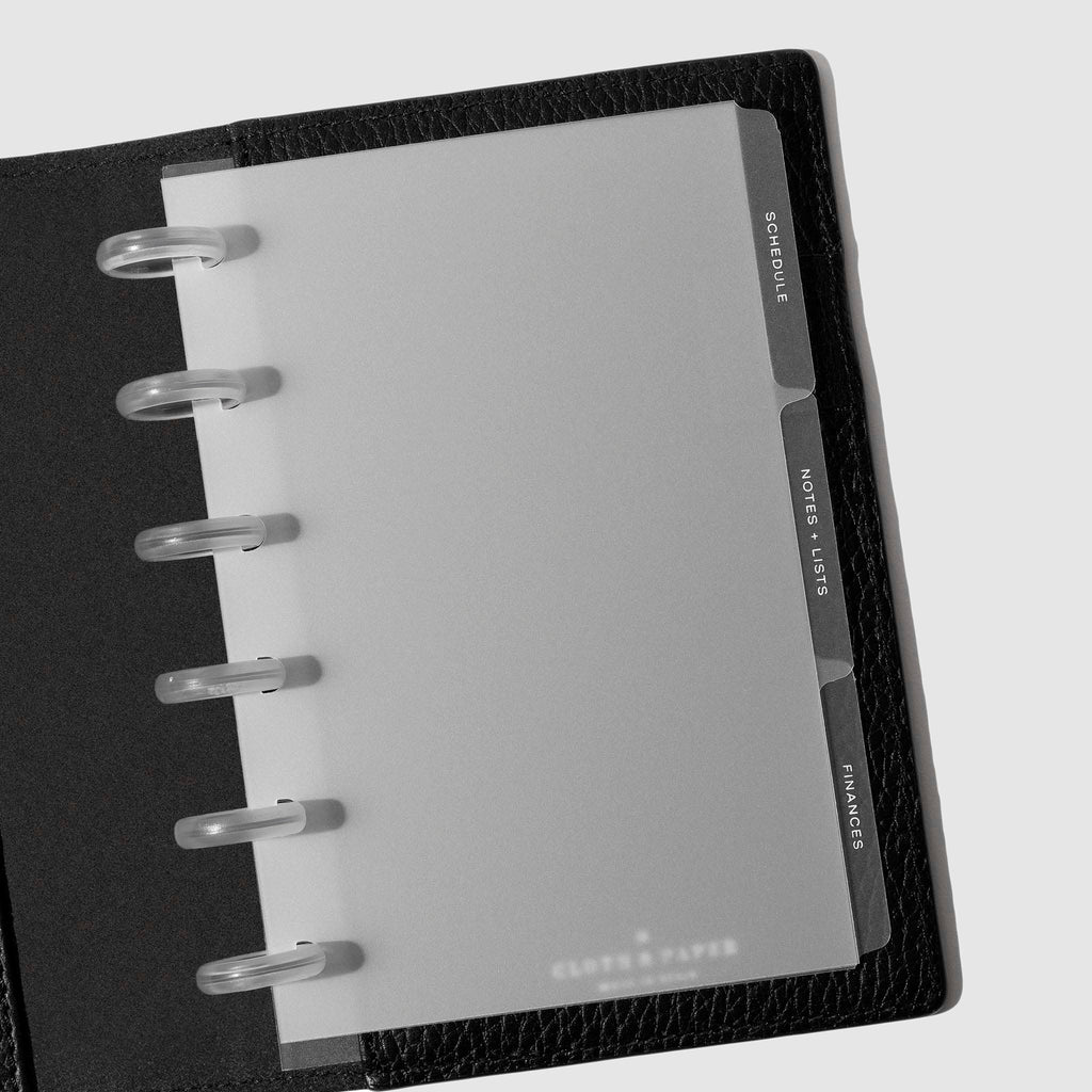 White foil tabs displayed in use inside a  leather folio.