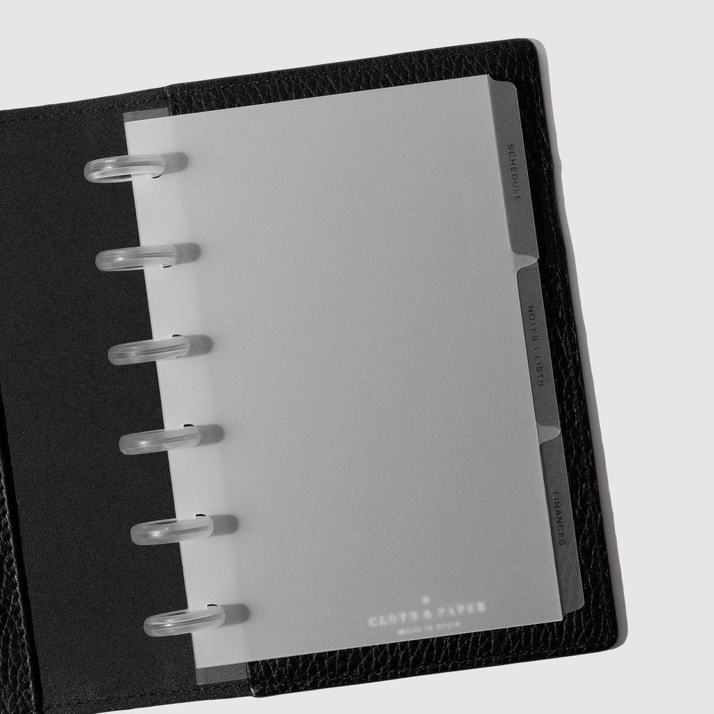 Black foil tabs displayed in use inside a  leather folio.