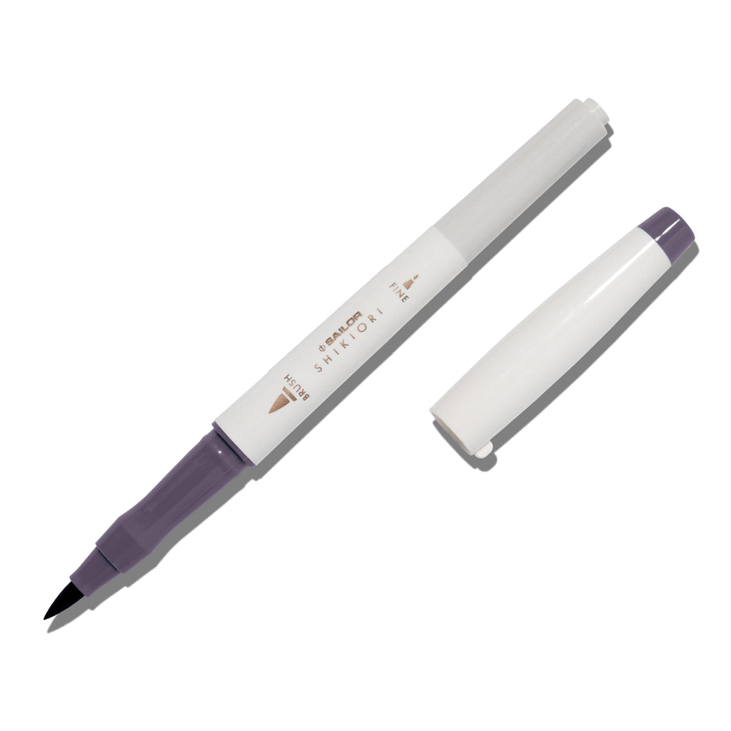 Brush pen displayed on a white background. It is uncapped with its brush nib exposed, and the cap lying parallel to the marker. Color pictured is Chushu. 