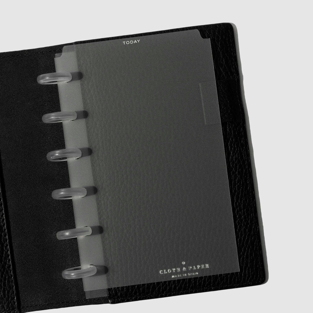 White  foil divider displayed in a black leather planner.