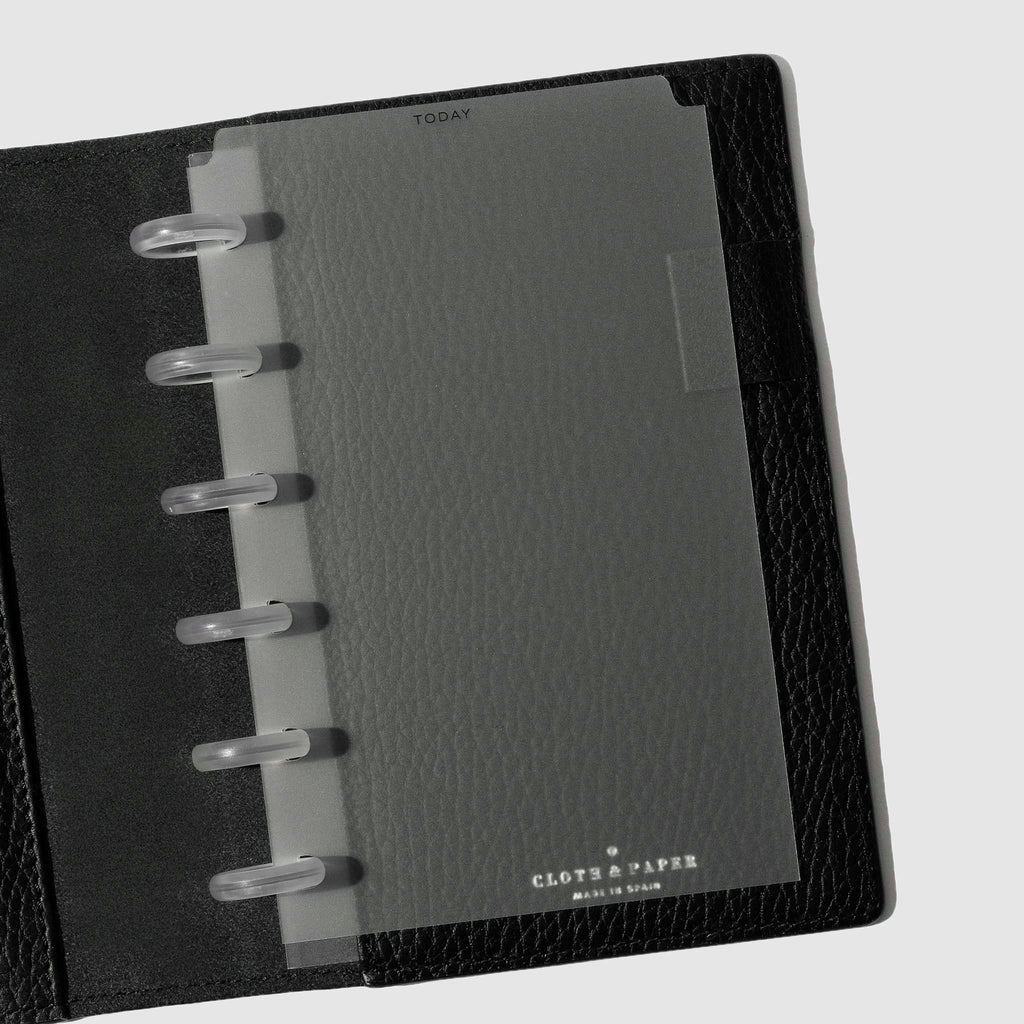 Black foil divider displayed in a black leather planner.