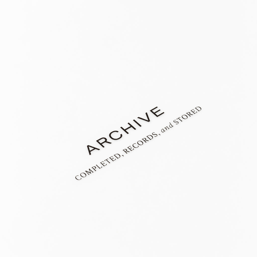Closeup of text reading "archive | completed, records, and stored"