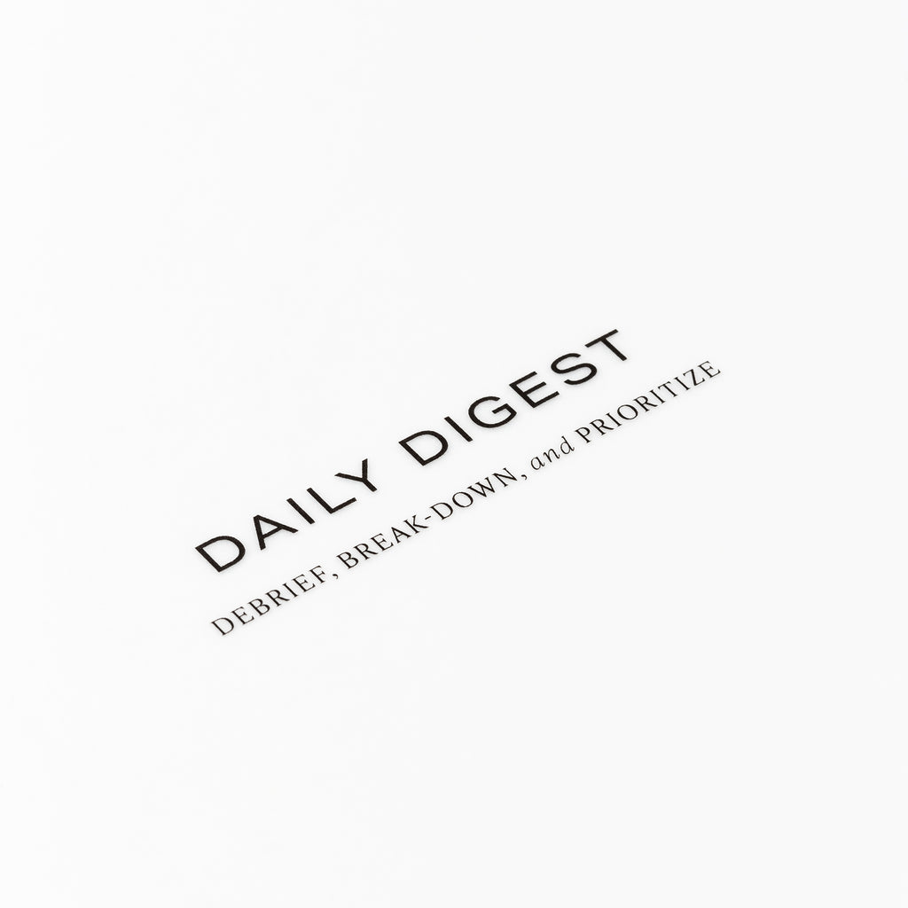 Closeup of text reading "daily digest | debrief, break-down, and prioritize"