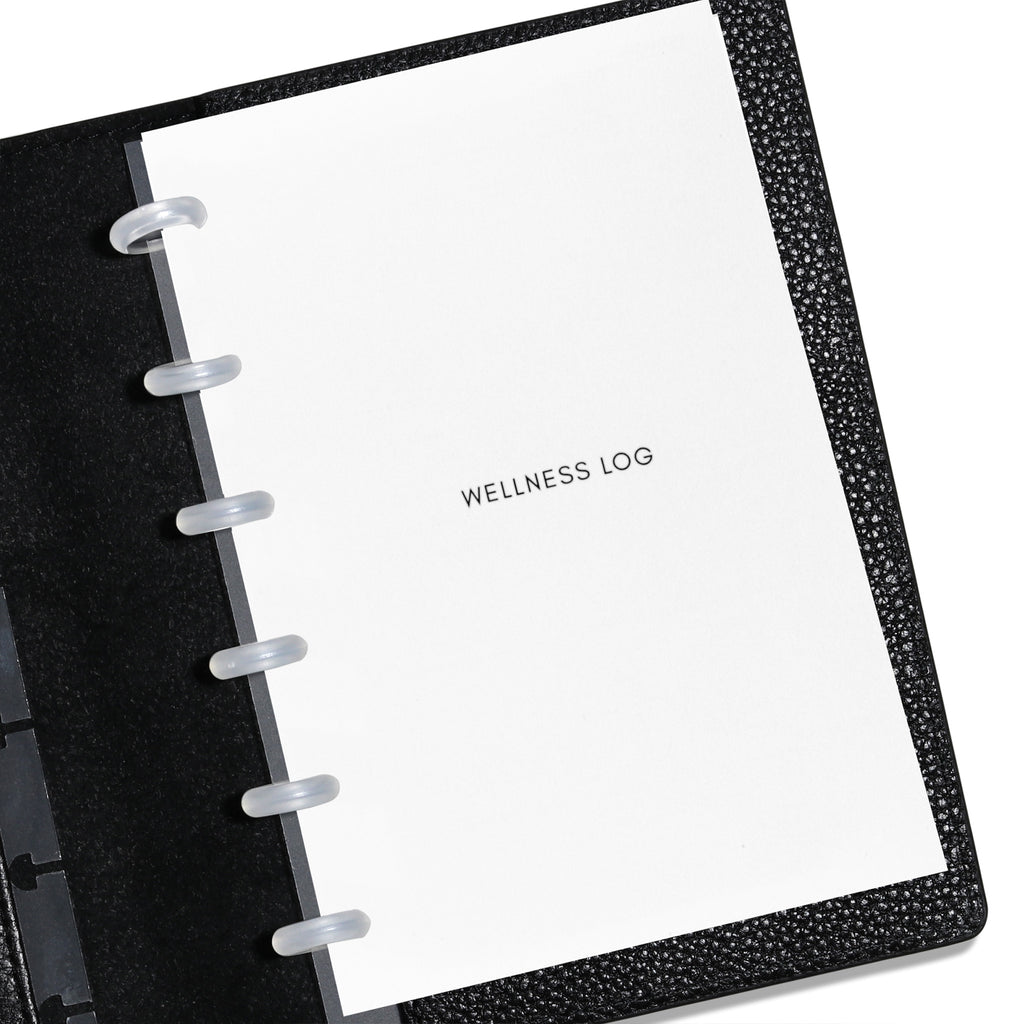 CP Petite Wellness Log insert displayed in a black leather planner. Title page is shown. 