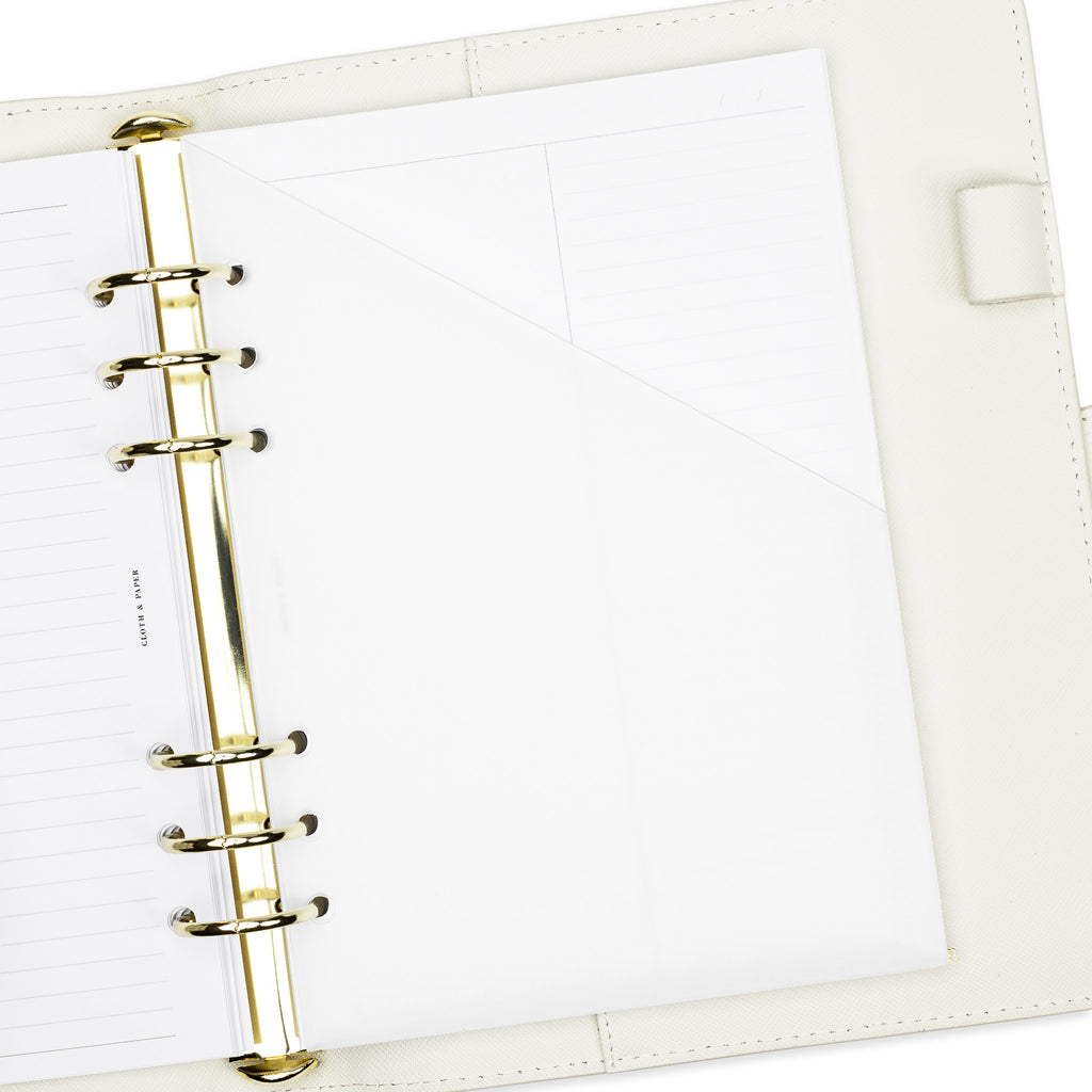 Folder in use inside a white leather agenda.