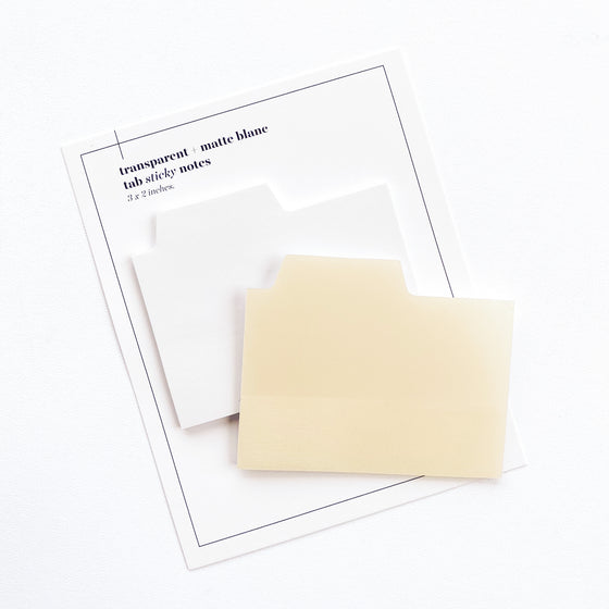 Blank Tab Sticky Note Set, Blanc, Cloth and Paper. Sticky note set displayed against a white background. The matte sticky note pad is attached to the sticky note backing, while the transparent sticky note pad is layered on top of it, turned slightly to the right.