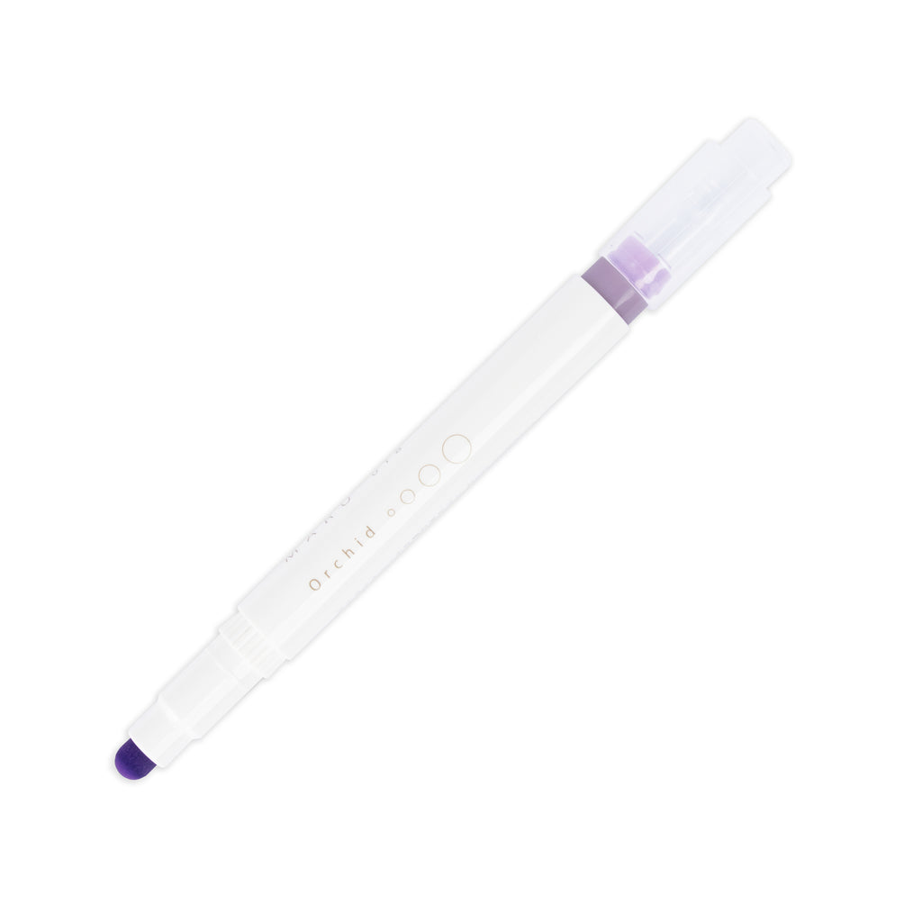 Orchid highlighter with tip exposed and cap posted to the end of its barrel on a white background.
