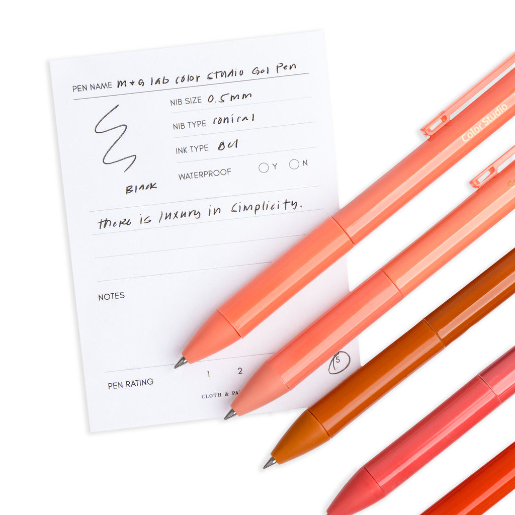 Close up shot of five pens resting on a pen test sheet.