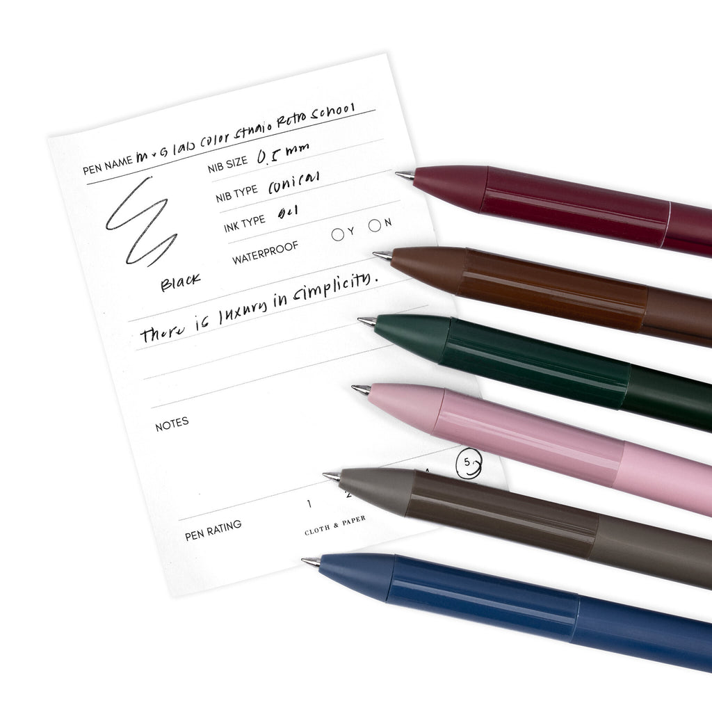 Full collection of six M&G Lab Color Studio Retro School pens resting on a pen test sheet.