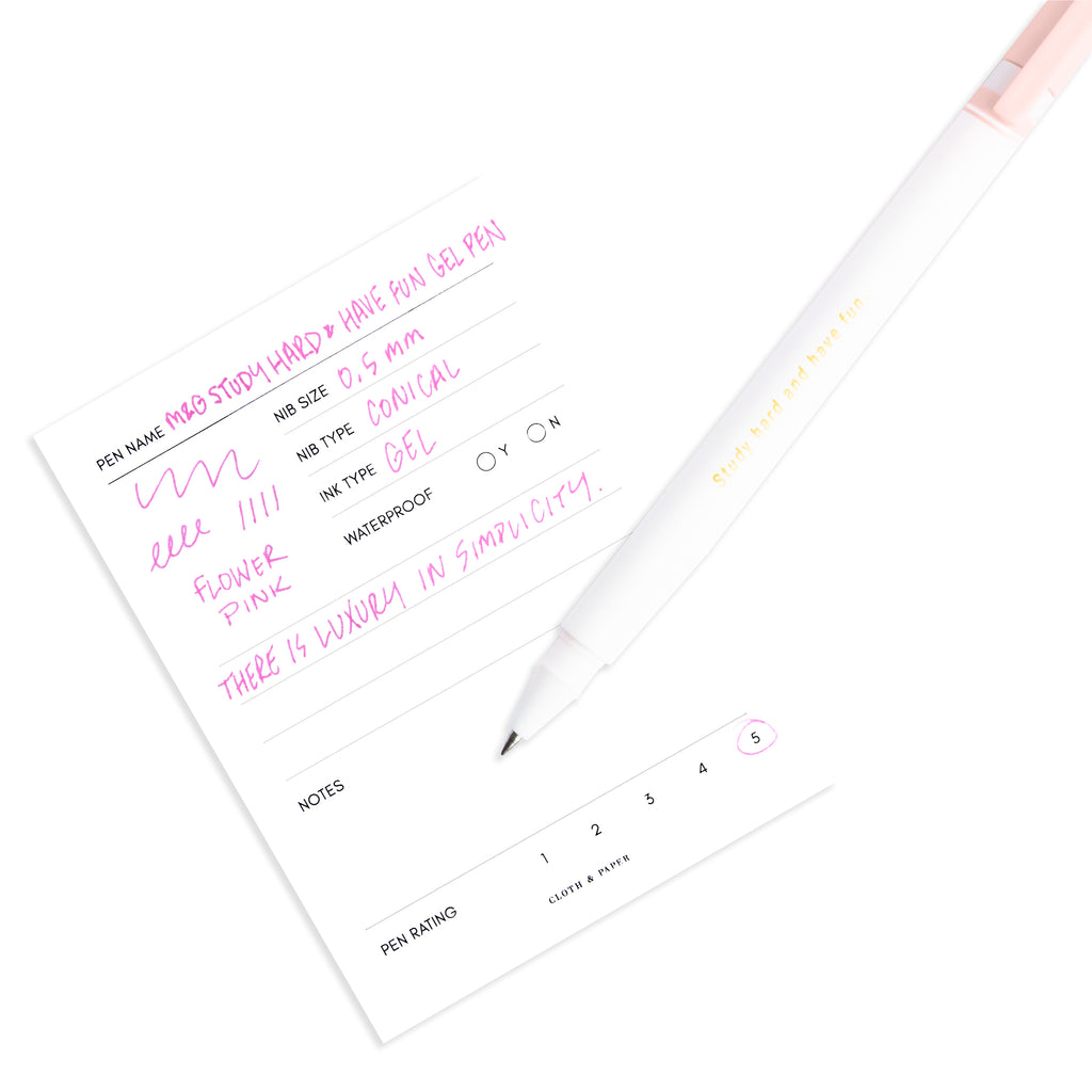 Flower Pink pen resting on a pen test sheet displaying a writing sample detailing the pen's specs.