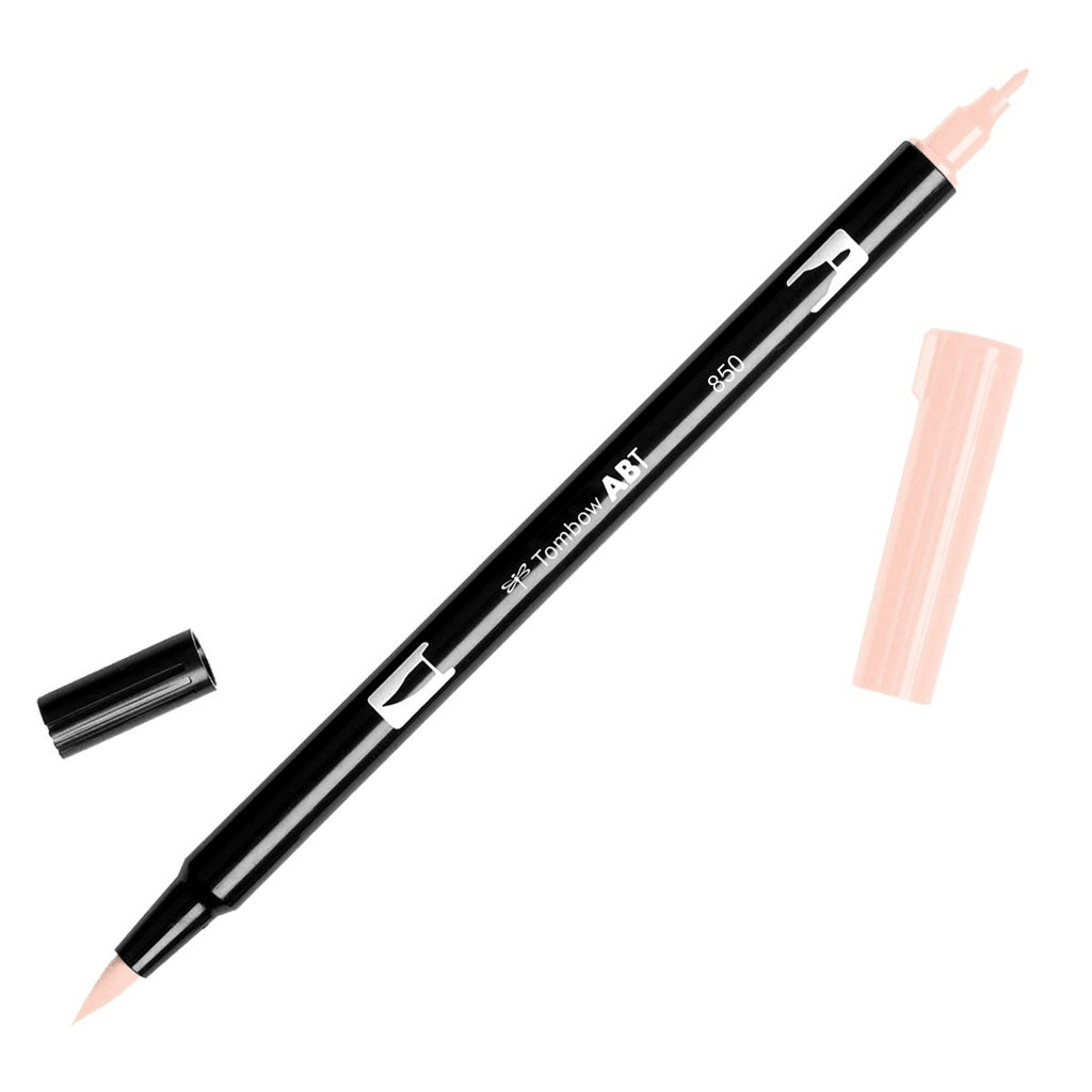 Tombow Dual Brush Art Marker, Light Apricot, Cloth & Paper. Art marker turned slightly to the right on a white background. It is uncapped on both ends showing the brush tip and fine tip.
