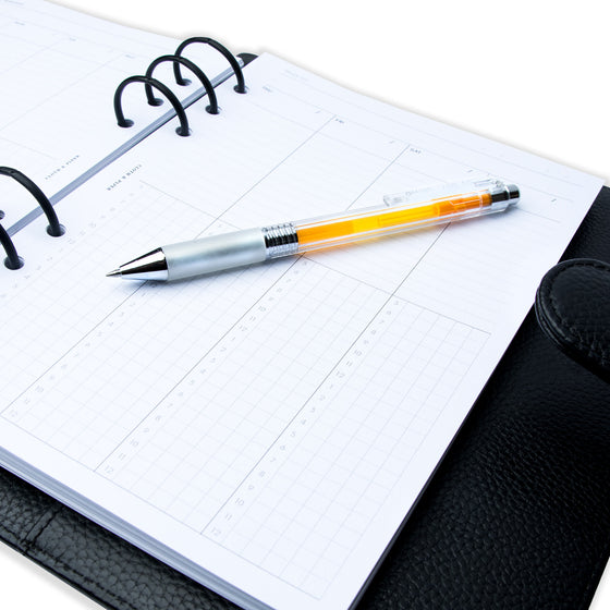 Weekly Schedule Planner Insert, Cloth and Paper. Close up image of inserts in a black leather ring bound planner. An orange pen rests on top of the inserts.