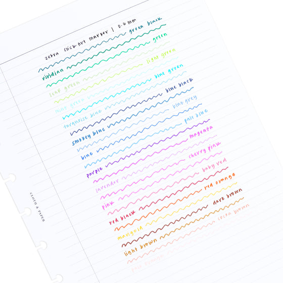 Test writing of all Zebra ClickArt Marker colors on a lined paper, on a white background, tilted slightly to the left.