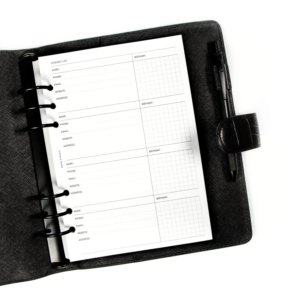Refreshed Contact List Planner Inserts styled inside a black leather agenda. There is a black pen in the agenda's pen loop.