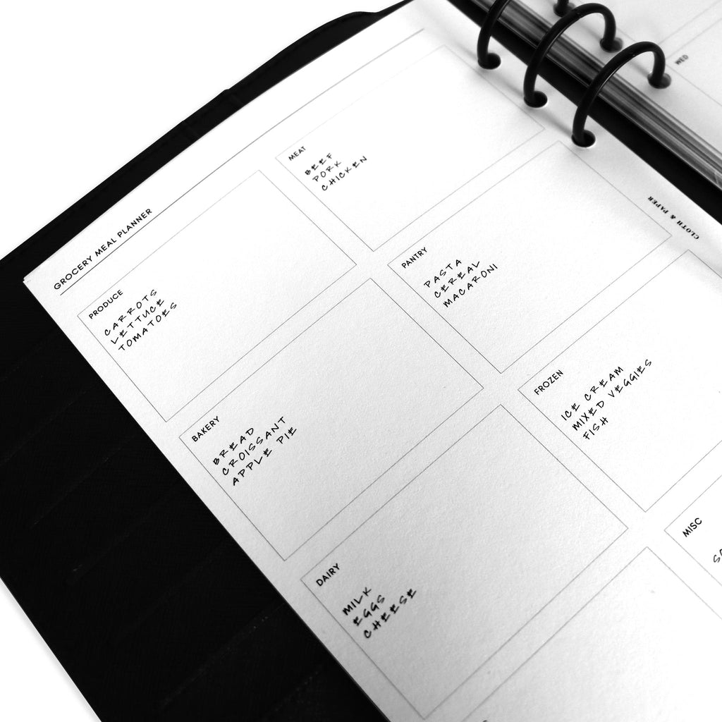 Close up of inserts in use inside a black leather planner.