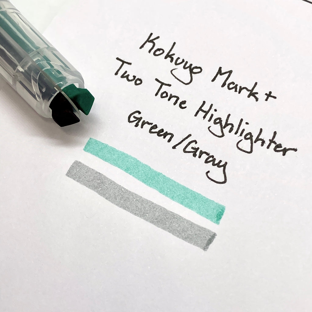 Close up on the highlighter's dual chisel tips resting on a sheet with a writing sample.