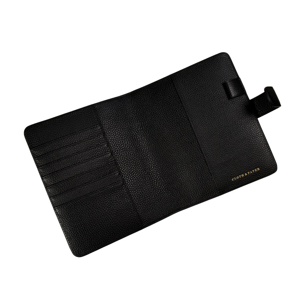 Black agenda cover opened to show the inside. The document pockets, credit card slots, passport pocket, and pen loop are shown.